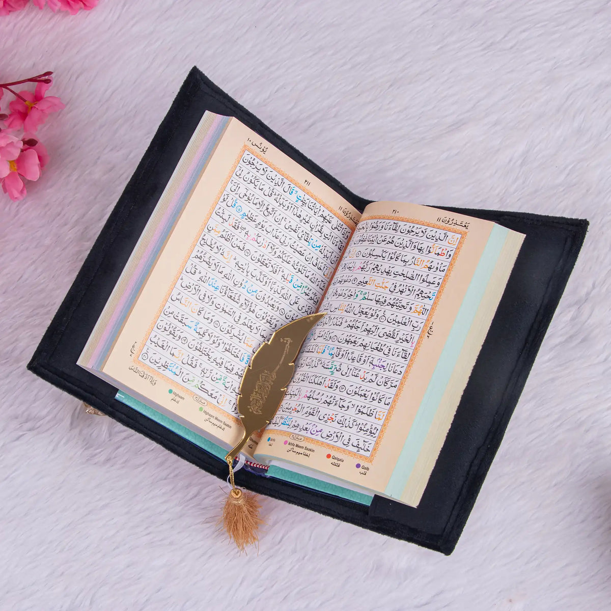 Color-coded Tajweed Quran with golden feather bookmark from the Black Sequence Bridal Sawab-e-Jariya Hamper, ideal for spiritual gifting.