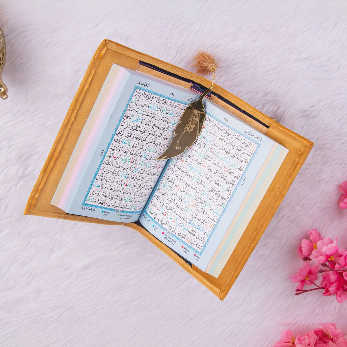 Golden Quran with colorful pages and gold feather bookmark, included in the Golden Sawab-e-Jariya - Bling Quran Gift Set for special occasions.