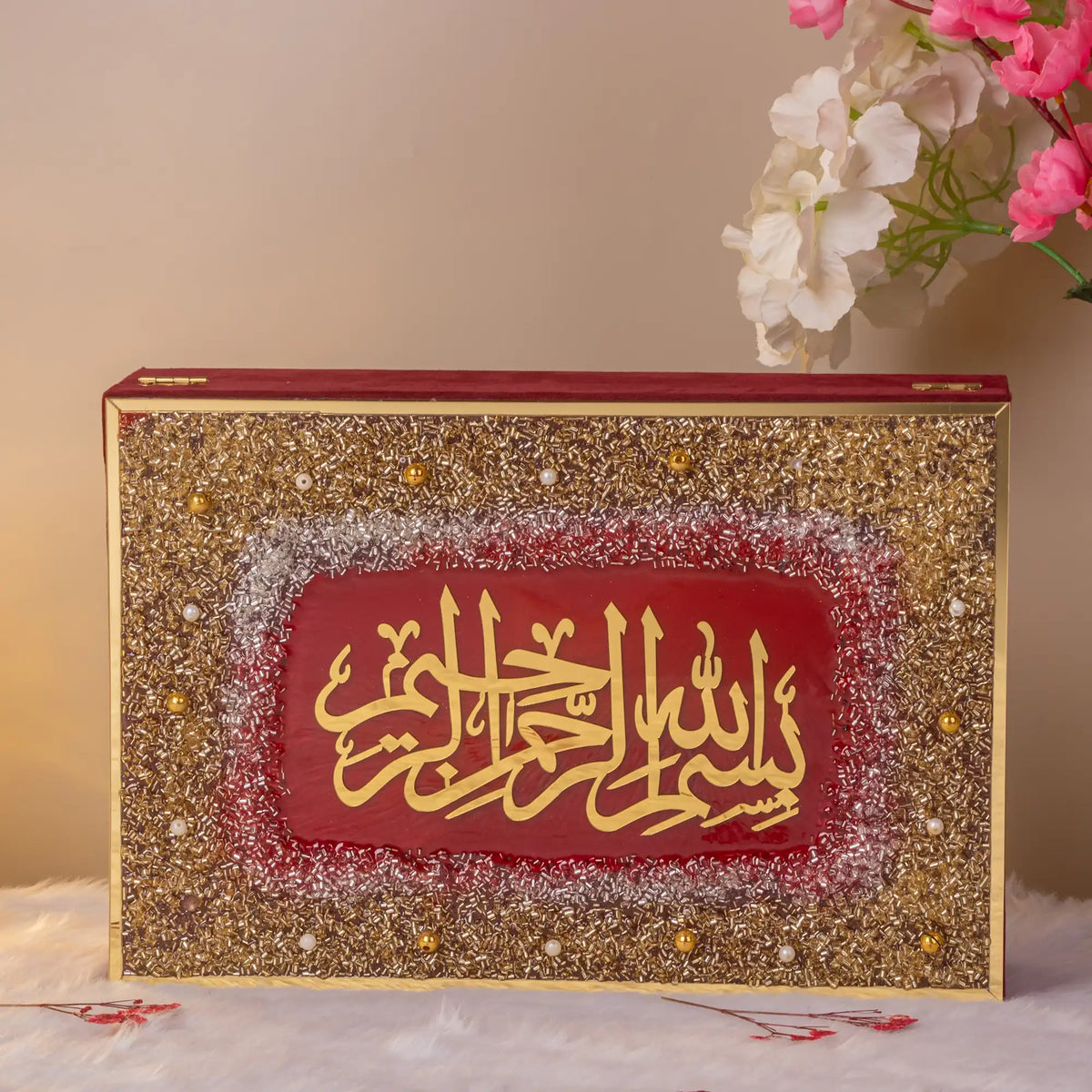 Close-up of glittered Quran gift box with Arabic calligraphy from the Maroon Sequence Rehal Hamper - Luxury Quran Gift Set. Handmade and ornate.