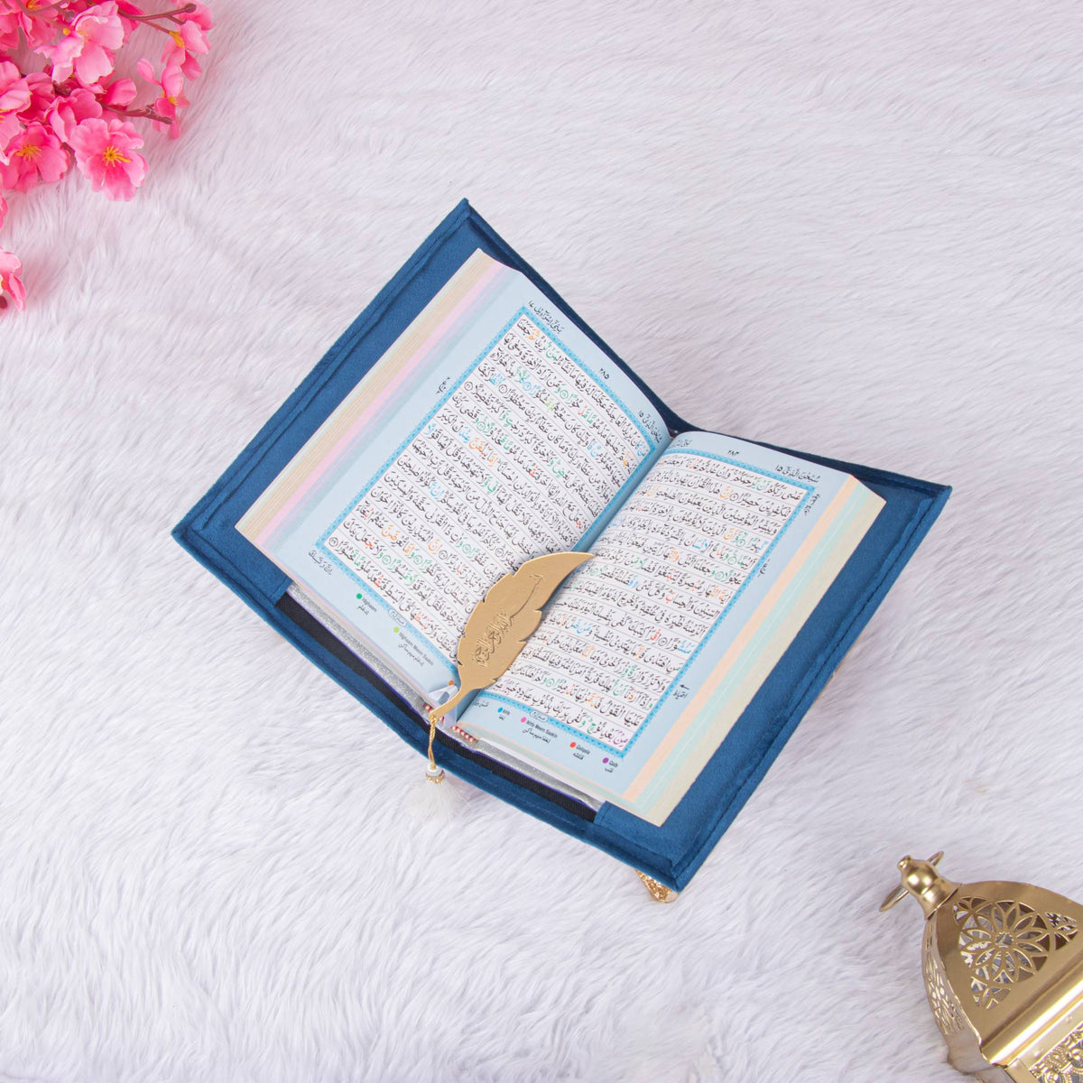 Open Personalised Velvet Quran - Color Coded with blue velvet cover and gold feather bookmark, featuring color-coded Arabic text for easy reading.