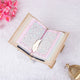 Open beige Personalised Velvet Quran - Color Coded with pink-tinted pages and gold feather bookmark, enhancing readability and elegance.