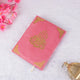 Flat lay of pink Kaaba Quran with gold Arabic calligraphy, a beautiful and thoughtful gift for women and prayer essentials.
