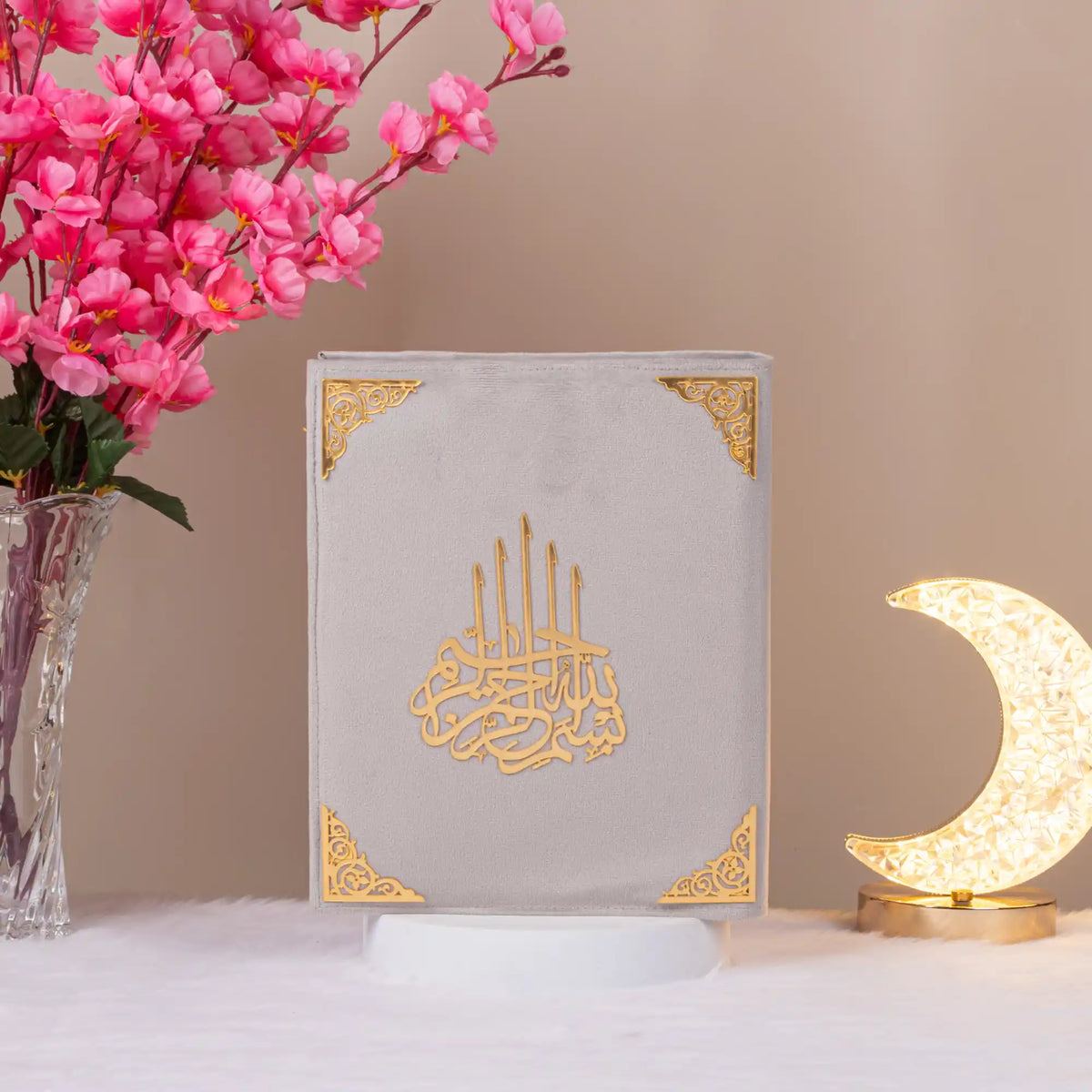 White velvet Kaaba Quran with gold embellishments, displayed upright with crescent lamp, ideal for religious and ceremonial gifting.