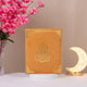 Orange velvet Kaaba Quran with gold embellishments, upright with crescent lamp, a unique and elegant religious gift box.