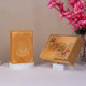 Golden Tilawat-e-Quran set with red floral accents and Quran, a luxurious Ramadan hamper for spiritual gifting.