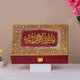Decorative box with gold and red design on a neutral background