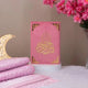 Pink velvet Quran with golden calligraphy displayed with floral decor, part of the Butterfly Quran Gift Set - Pink Butterfly Sawab-e-Jariya.