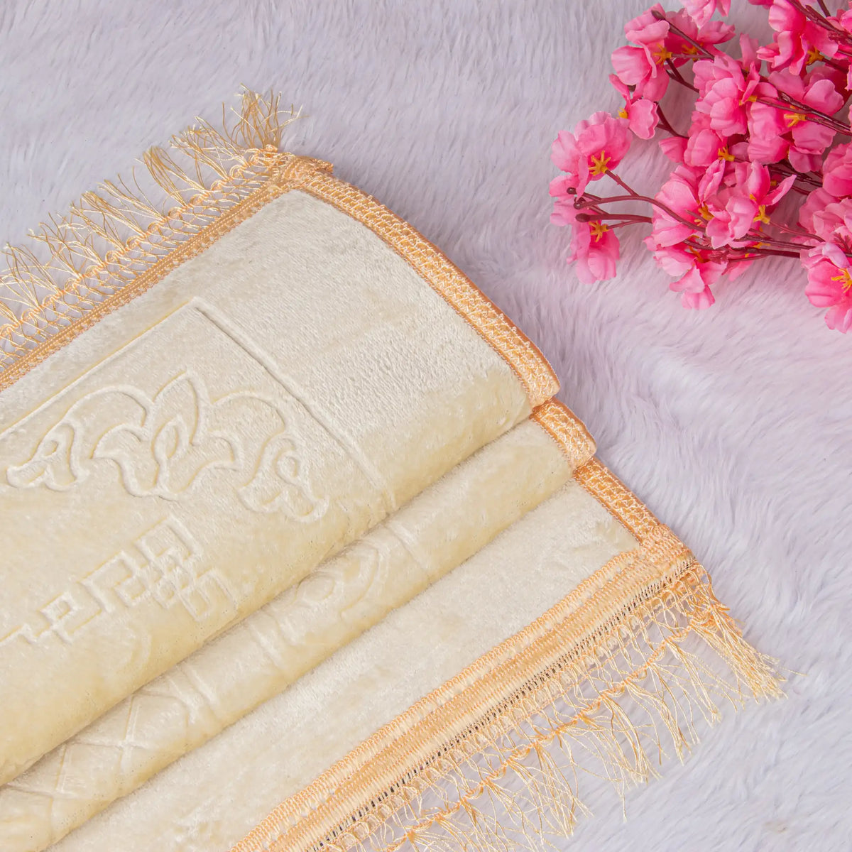 Close-up of soft offwhite janamaz with golden fringes from the Customised Salah Combo Hamper. Perfect for enhancing daily prayer experience.