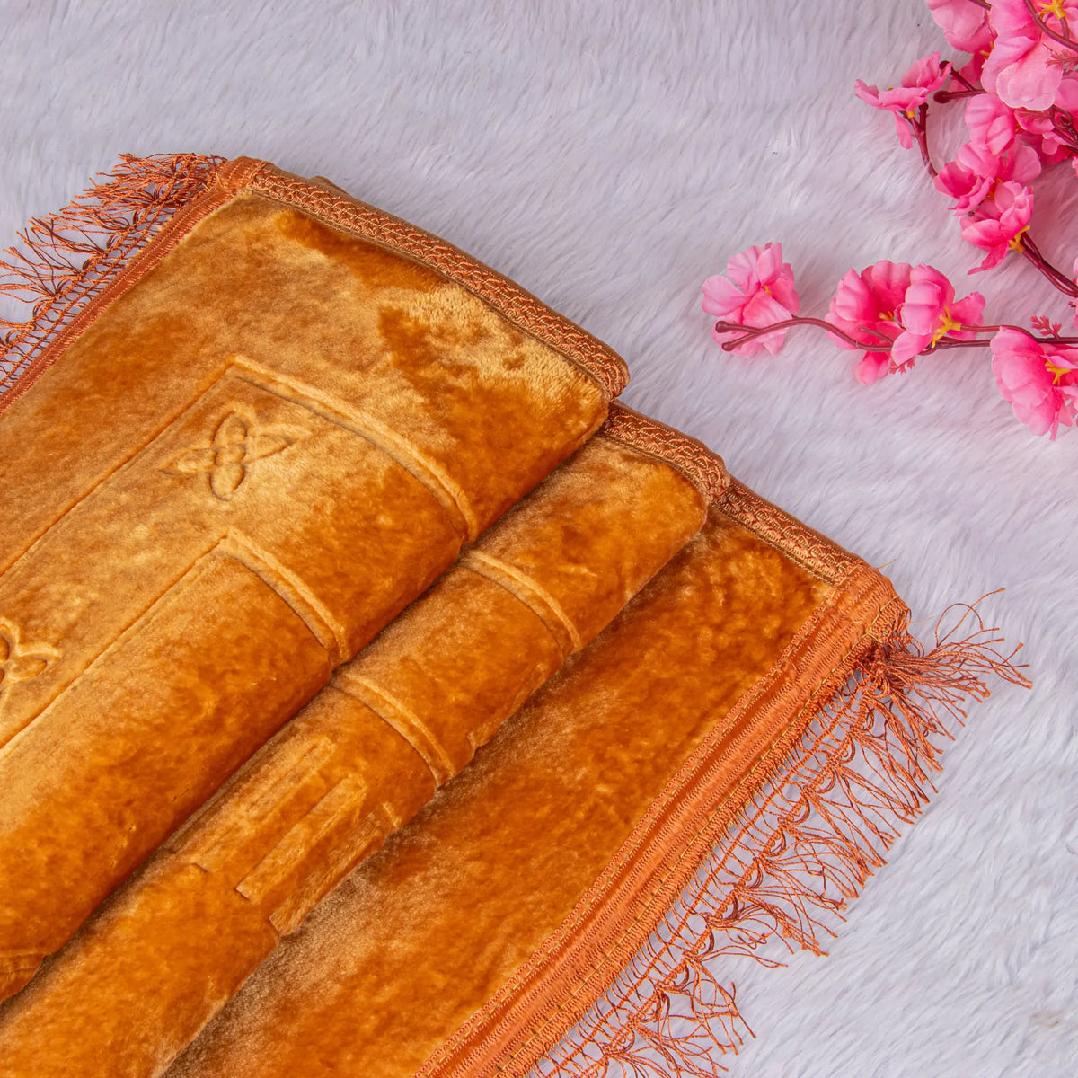 Golden velvet Janamaz with intricate border detailing from the Golden Salah Combo Hamper. Premium Islamic prayer mat gift.