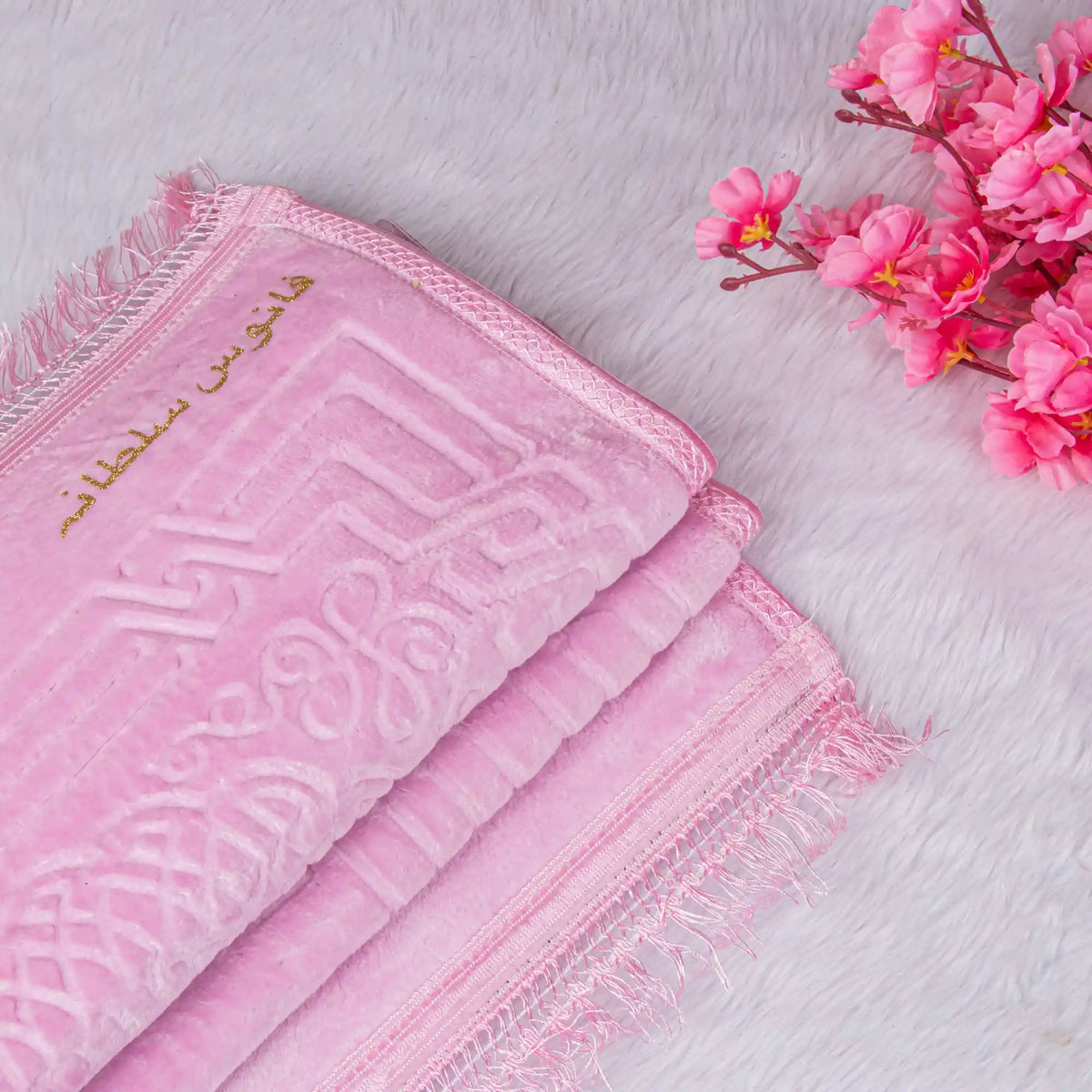 Soft pink Janamaz with intricate embroidery from Custom Pink Salah Hamper. Adds elegance and comfort to daily prayers.