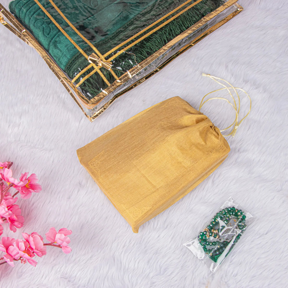 Golden drawstring pouch and packaged Tasbeeh from the Green Stones Tilawat-e-Quran Gift Hamper, ideal for gifting during religious occasions.