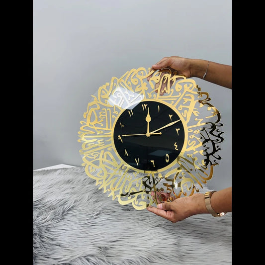 Elegant Surah Al Ikhlas Wall Clock held in hands, showcasing intricate gold calligraphy and durable acrylic design for modern interiors.