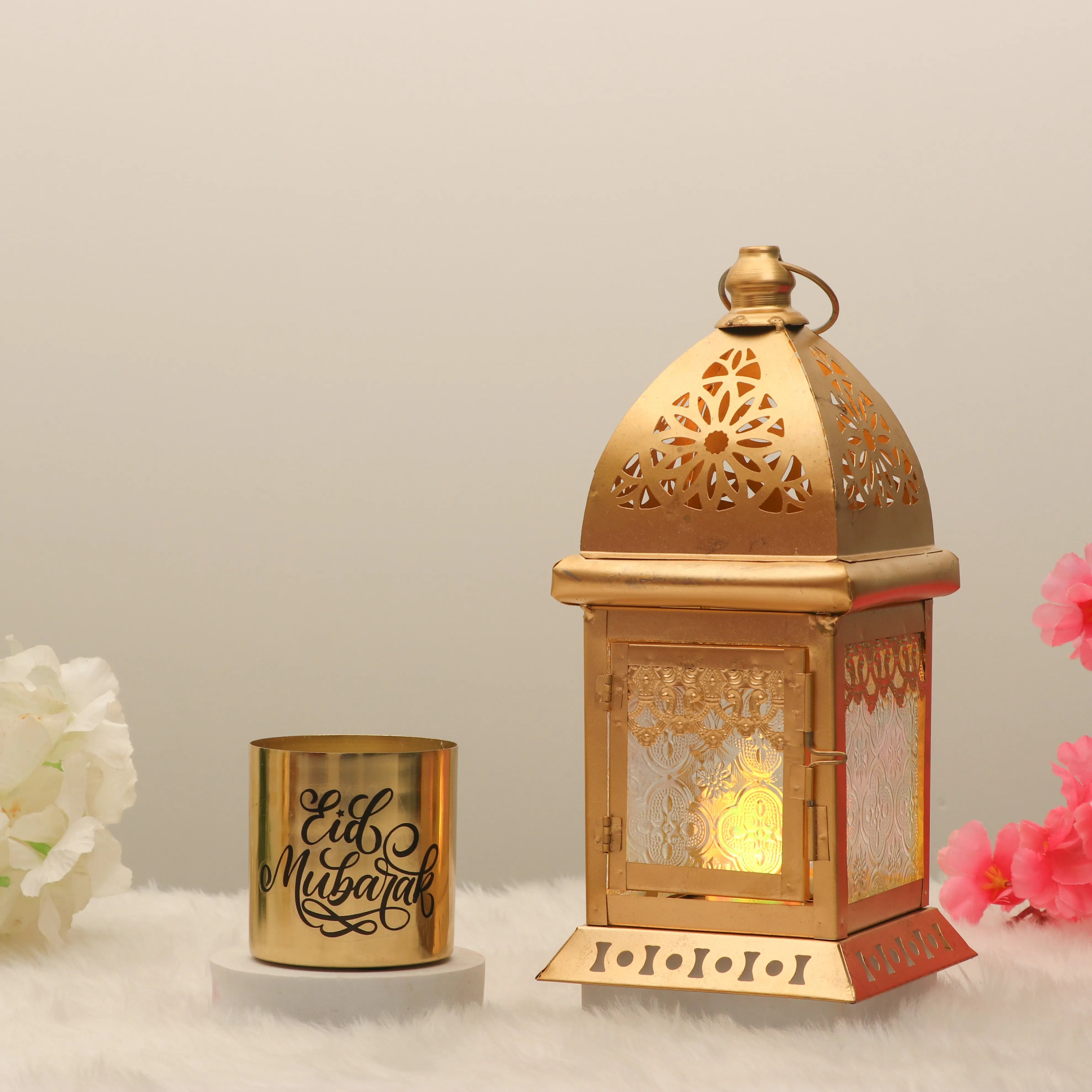 Radiance Decor Set - Eid Decor Set Candle Lantern featuring a gold 9-inch lantern with intricate cutouts and a gold 'Eid Mubarak' candle, ideal for festive home decor. Main image