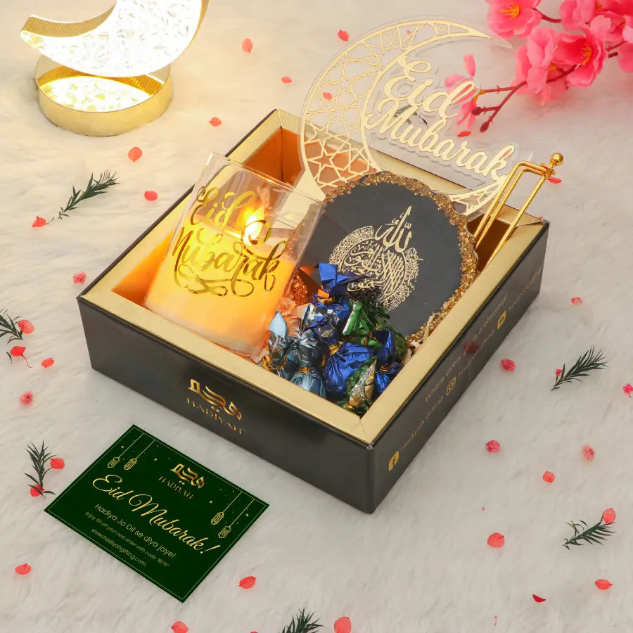 Tawakkul Eid Hamper - Elegant Eid gift hamper featuring Eid Mubarak candle, Islamic art, chocolates, and greeting card in a premium gift box.