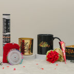 Afiyah Eid Hamper - Eid Gift Hamper for Women shown with black mug, gold candle holder, red hijab, rose, and henna cone for festive gifting.