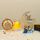 Tawakkul Eid Hamper - Premium Eid gift hamper showcasing Islamic art on stand, Eid Mubarak candle, and chocolates for festive celebrations.