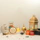 Sukoon Eid Hamper - Eid Hamper Gifts | Premium Items displayed with bakhoor, golden lantern, nuts, cookies, and Eid-themed decor on white fur.