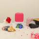 Unboxed Hidaya Eid Hamper contents including a pink hijab, red rose, assorted scrunchies, chocolates, and a pink jewelry case for Eid gifting.
