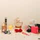 The Nazarana Eid Set - Gift Set | Elegant Essentials displayed with festive items including a candle, mug, hijab, lantern, and Eid Mubarak decor.
