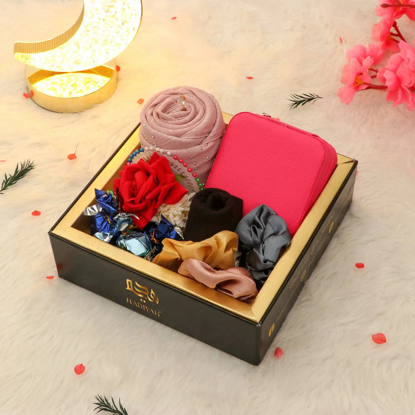 Hidaya Eid Hamper - Eid gift hamper for wife featuring a pink hijab, scrunchies, chocolates, and a pink jewelry box in a premium black gift box. Main image