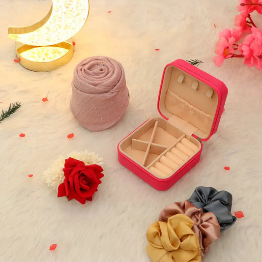 Open pink jewelry box from Hidaya Eid Hamper displayed with a pink hijab, scrunchies, and decorative rose, ideal Eid gift for women.