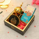Jannah Eid Hamper - Celebrate Eid with Premium Gifts featuring black Ayatul Kursi frame, golden Bakhoor burner, almond cookies, and treats in a luxury gift box.