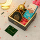 Gift set with cookies, candies, and a card on a decorative surface