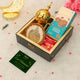 Gift box with cookies, a card, and decorative items on a light background