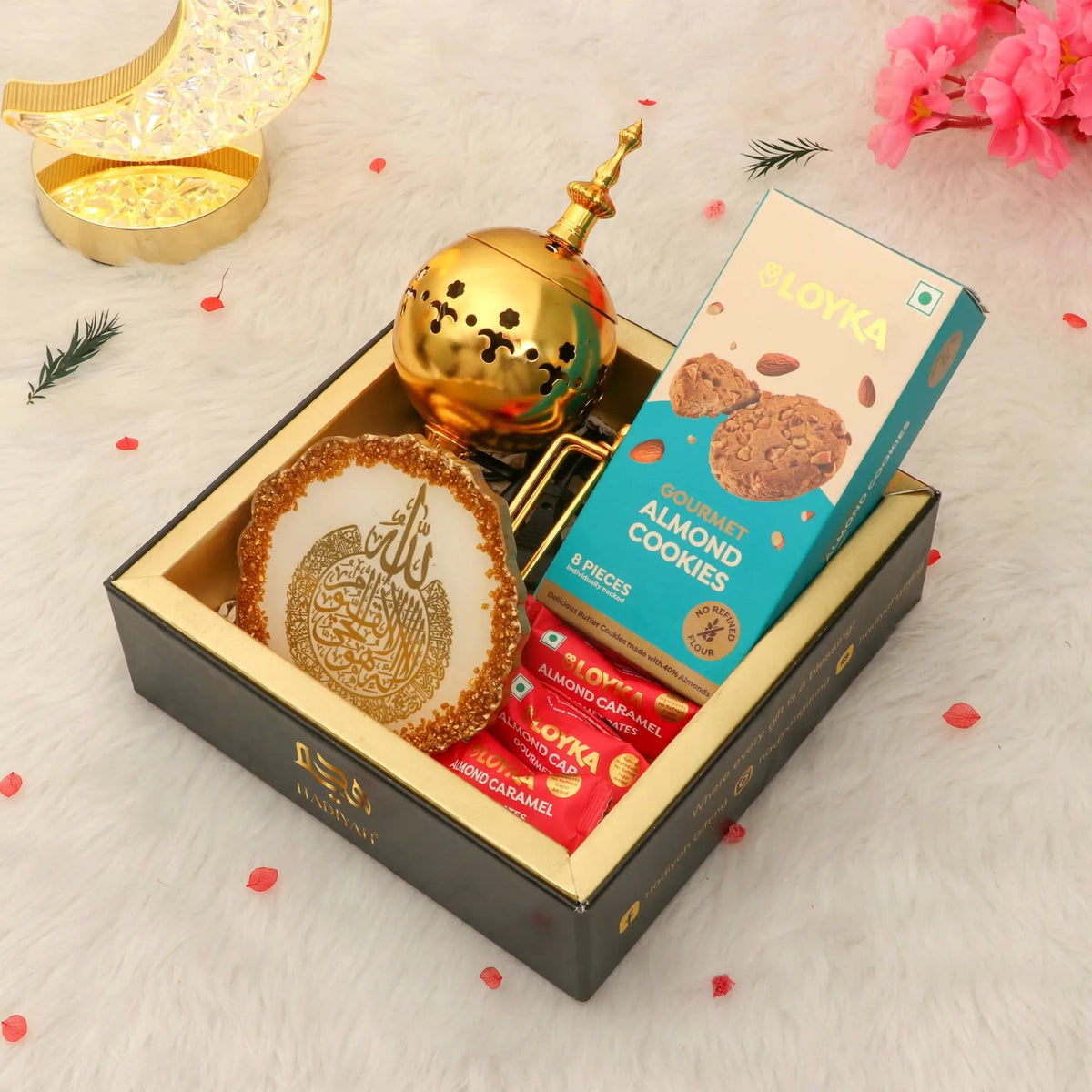 Jannah Eid Hamper - Celebrate Eid with Premium Gifts including white Ayatul Kursi frame, golden incense burner, gourmet almond cookies, and sweets in an elegant box.