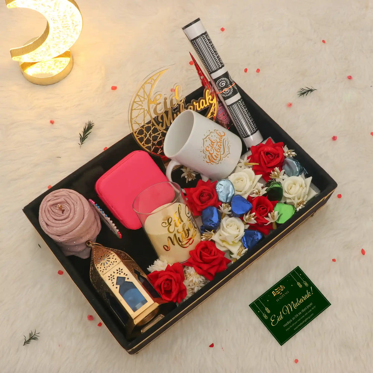 Gift set with roses, mugs, and decorative items on a light background