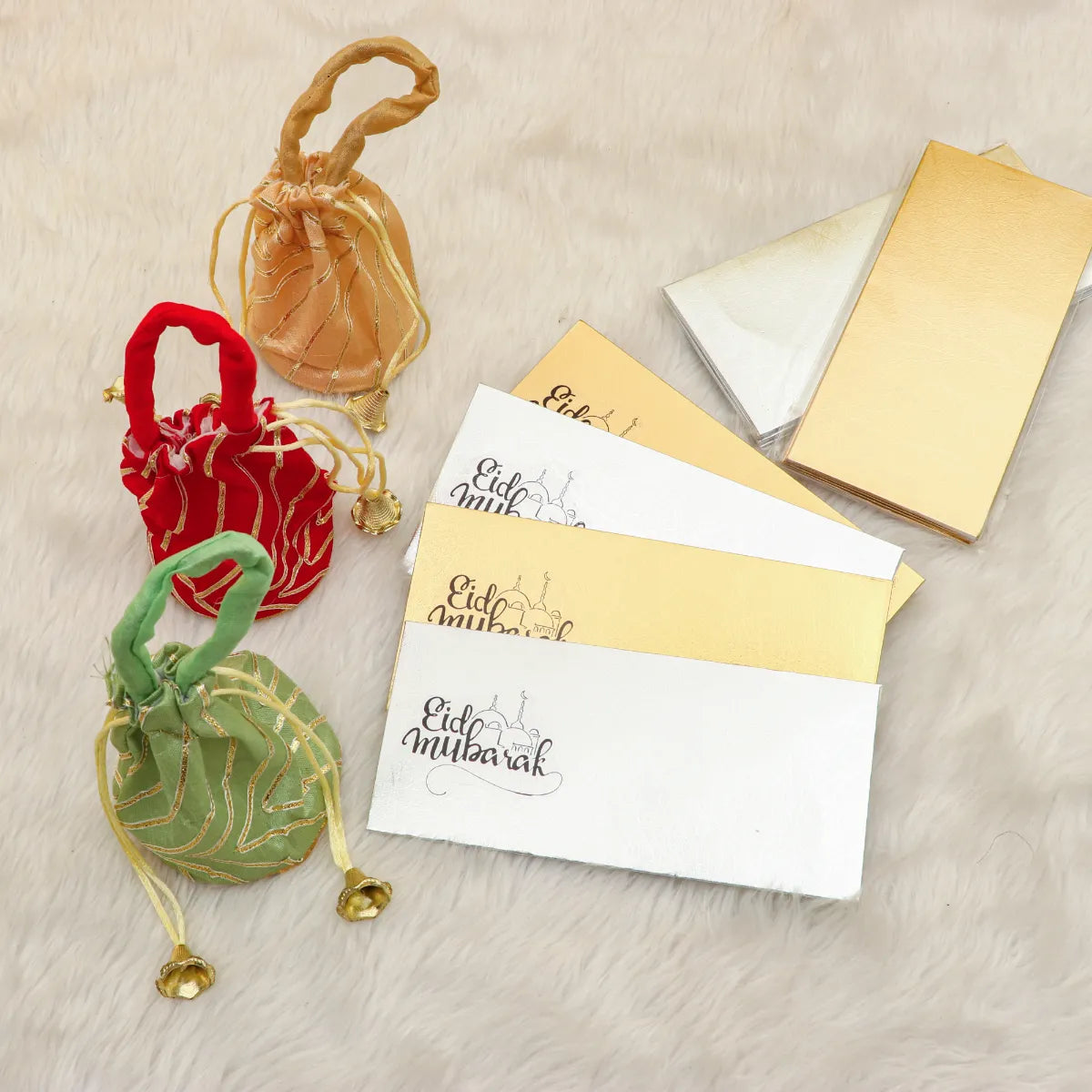 Eidi Luxe Gift Set with gold and silver Eid gift set envelopes and colorful Eidi potlis on a soft fur background. Ideal for Ramadan and Eid gifting.