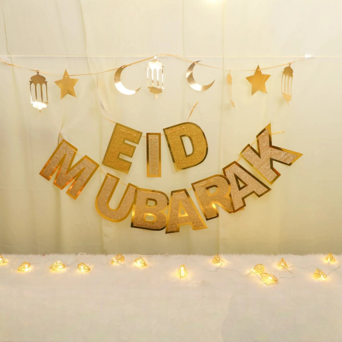 Starry Eid Delight Decor Set with gold 'Eid Mubarak' banner, moon and star garland, and warm fairy lights for festive home decoration.