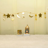 Lunar Serenity Decor Set - Eid Decor Set with gold star and moon banner, medium lantern, and Eid Mubarak scented candle for festive home decor.