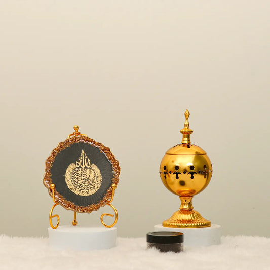 Ayat Serenity Decor Set featuring black Ayatul Kursi frame, ornate gold bakhoor burner, and oud jar. Perfect for Ramadan and Eid home decoration.