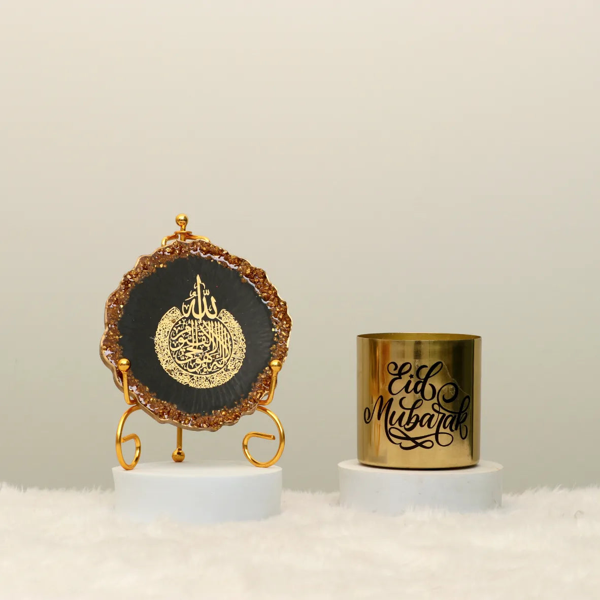 Divine Light Decor Set - Eid Decor Set featuring a black and gold Ayatul Kursi frame and a gold Eid Mubarak candle. Elegant Islamic home decoration.