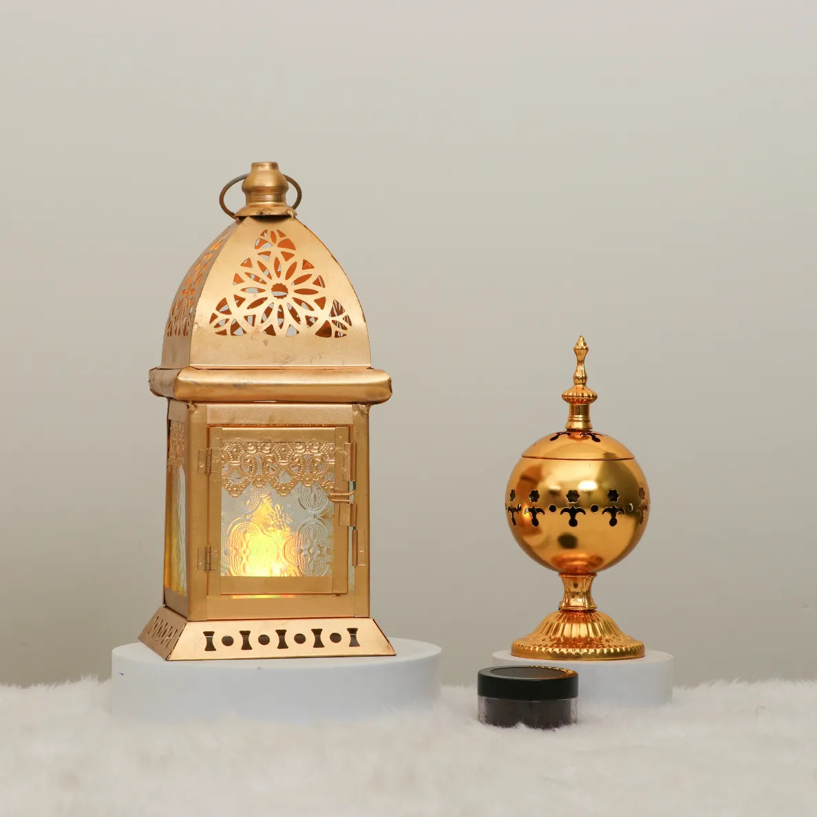 Oud Al-Fitr Decor Set featuring a golden lantern with intricate cutouts and a traditional bakhoor burner, ideal for Eid ambiance and home decor. Main image