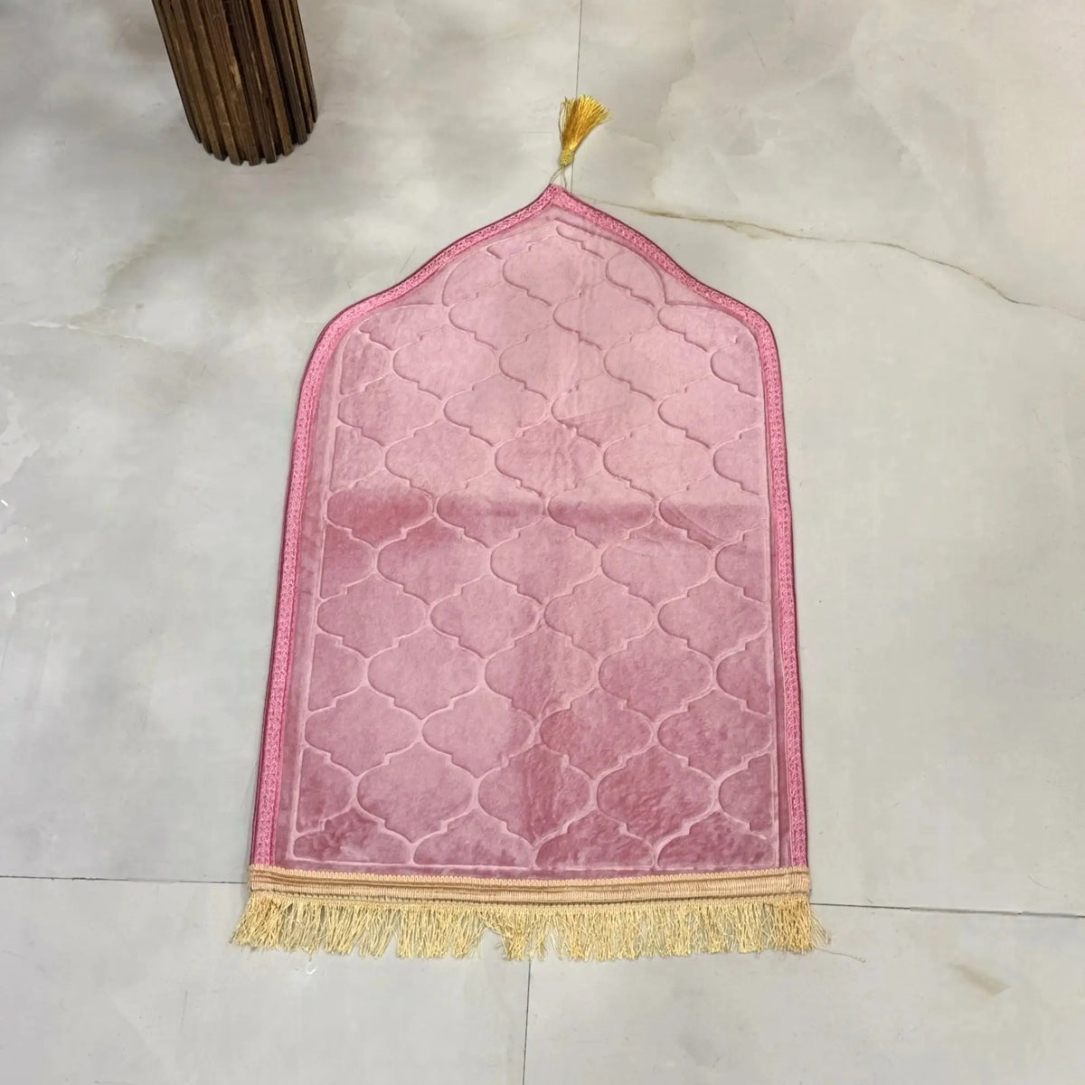 Kids Dome Janamaz - Perfect Prayer Rug for Kids in soft pink velvet, dome-shaped with gold tassels, laid flat on a marble floor.