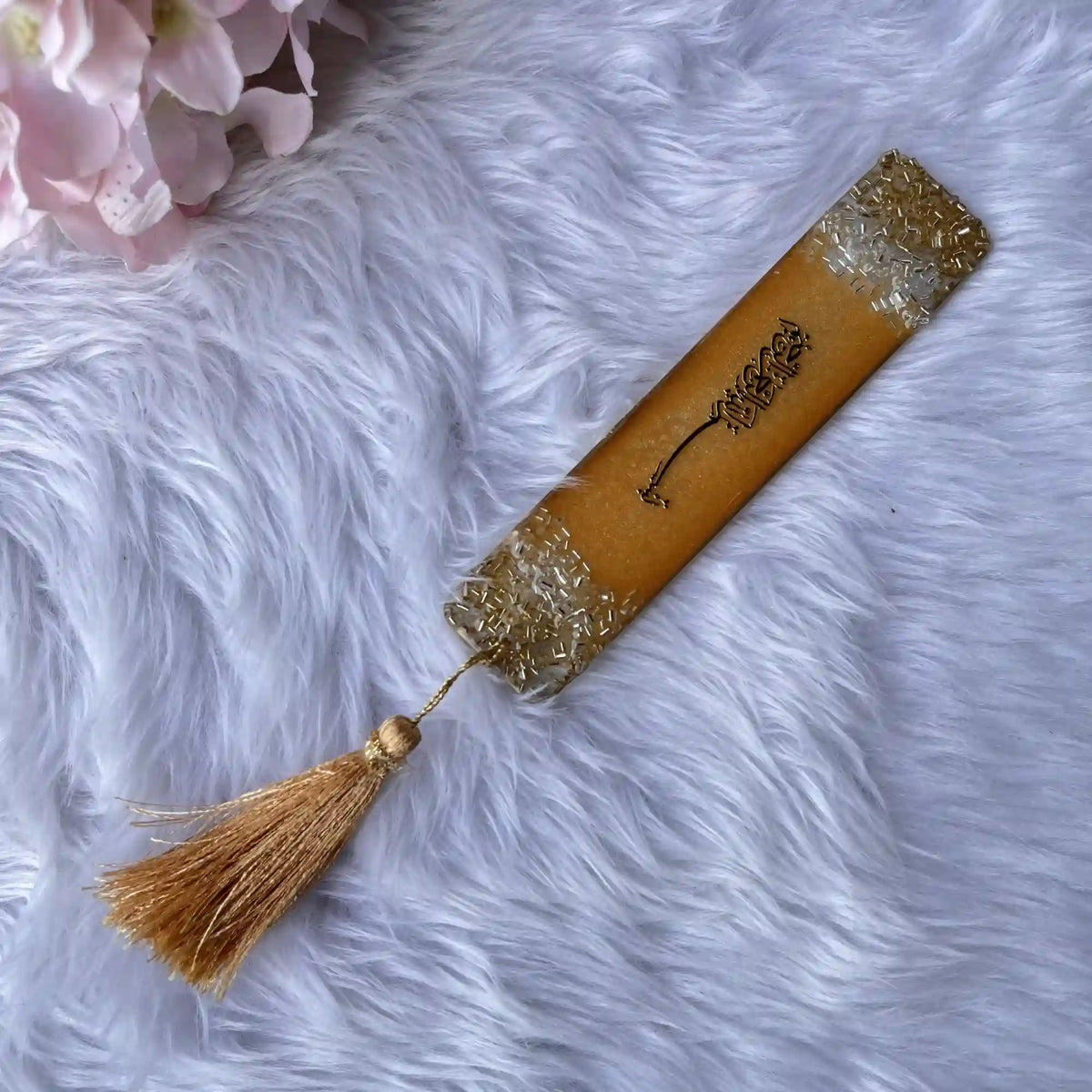 Islamic personalized bookmark in golden resin with elegant Arabic calligraphy and gold tassel, ideal as a wedding favor or sacred text accessory.