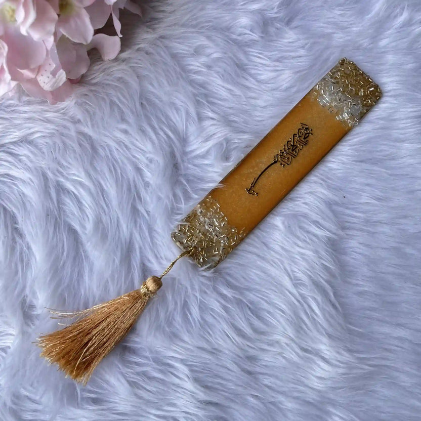 Islamic personalized bookmark in golden resin with elegant Arabic calligraphy and gold tassel, ideal as a wedding favor or sacred text accessory. Main image