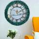 Green Geode Wall Clock - Timeless Elegance | Resin Decor displayed on a white wall beside a yellow chair, featuring a white marble face and emerald geode frame.