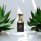 Adam - Premium Luxury Attar placed between green succulents, showcasing alcohol-free ittar perfect for Ramadan and EID gifts.