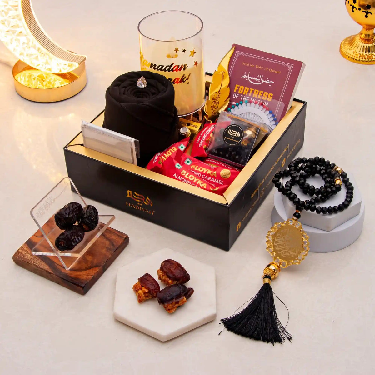 Gift box with dates, jewelry, and other items on a decorative surface