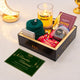 Gift set with candles, cards, and other items on a white surface with a 'Ramadan Mubarak!' card.