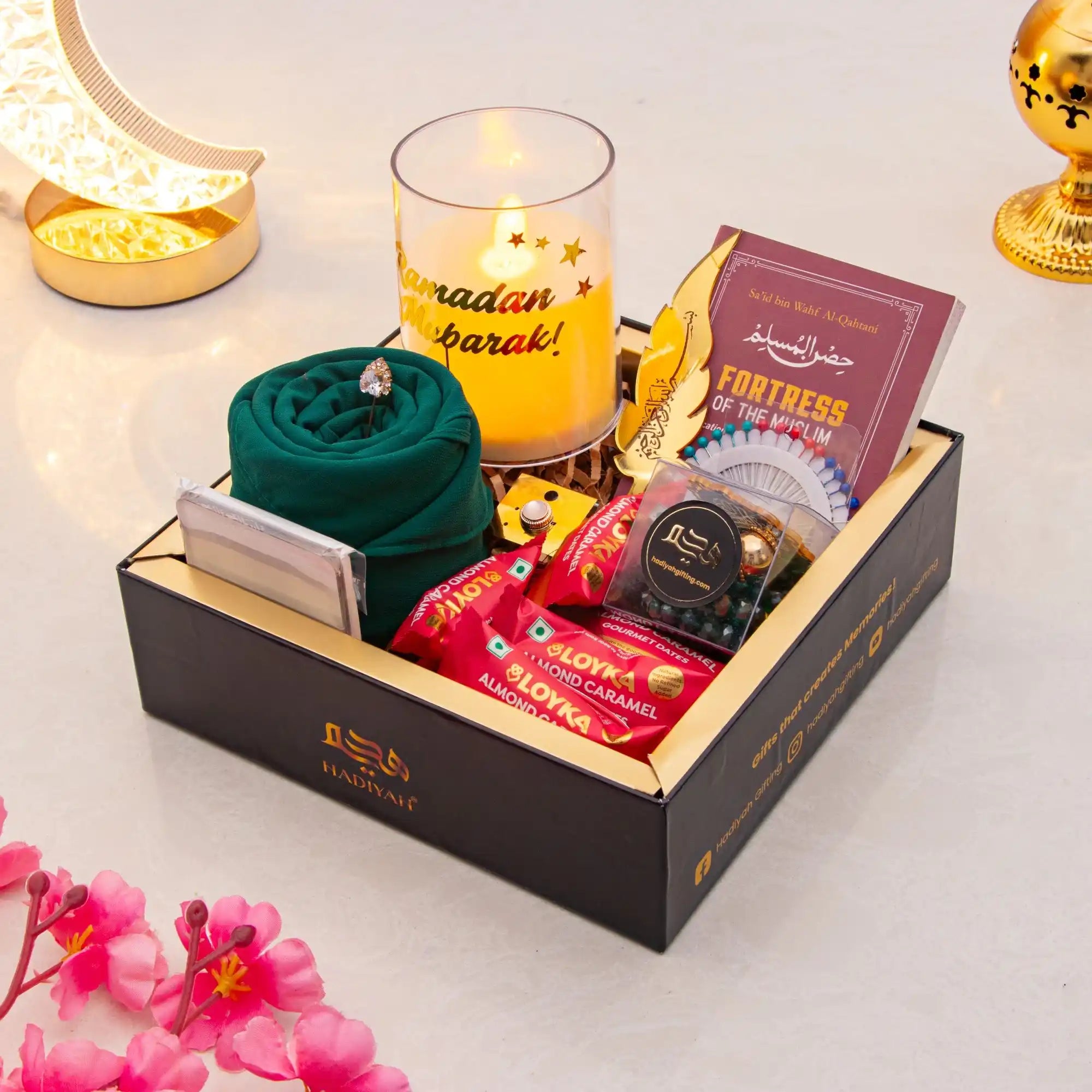 Gift set with candles, chocolates, and other items on a light background Main image