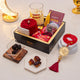 Gourmet gift set with dates, a candle, and a bracelet on a light background