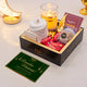 Gift box with candles, cards, and snacks on a decorative background