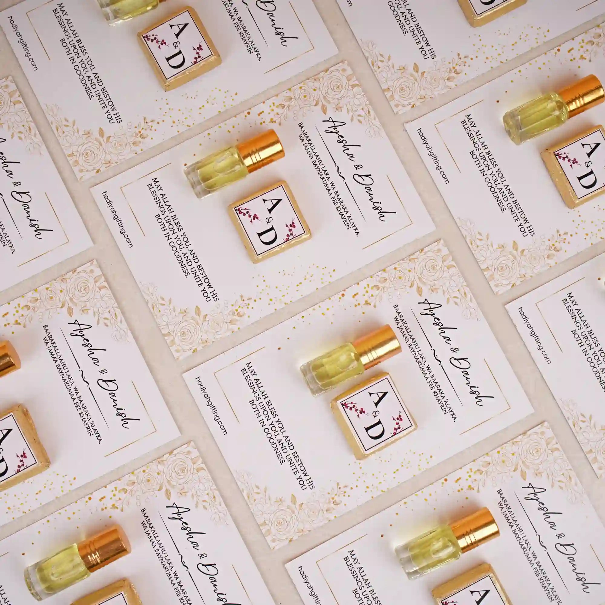 Premium Ittar & Chocolate Customised Card Favors for Nikah featuring gold-capped ittar bottles and monogrammed chocolates on floral cards.