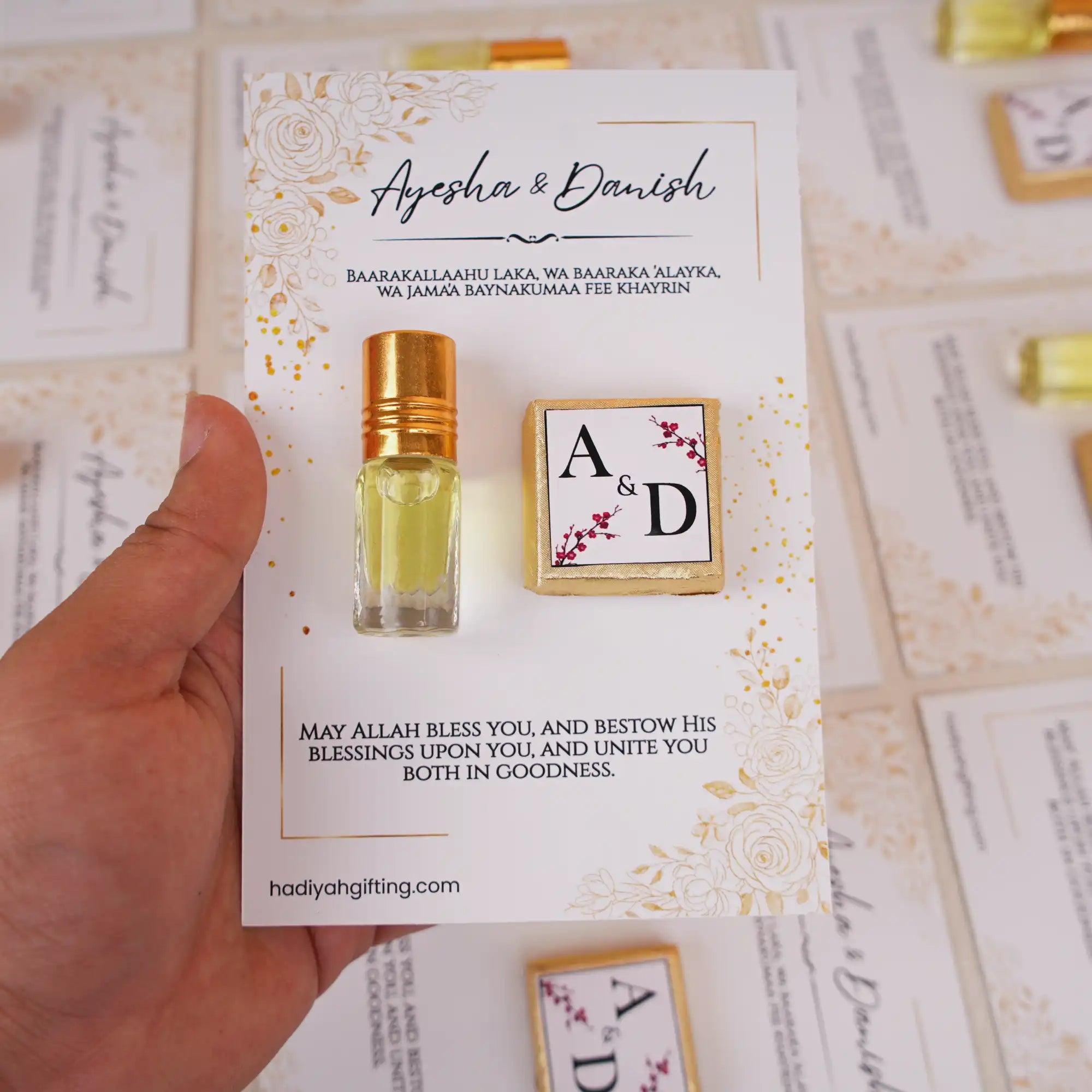 Premium Ittar & Chocolate Customised Card Favors for Nikah featuring a mini perfume bottle and personalized chocolate on floral gold-accented card. Main image