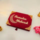 Closed red Jannah Treasures Ramadan Hamper box with 'Ramadan Mubarak' and crescent moon design, perfect for elegant Ramadan gift presentation.
