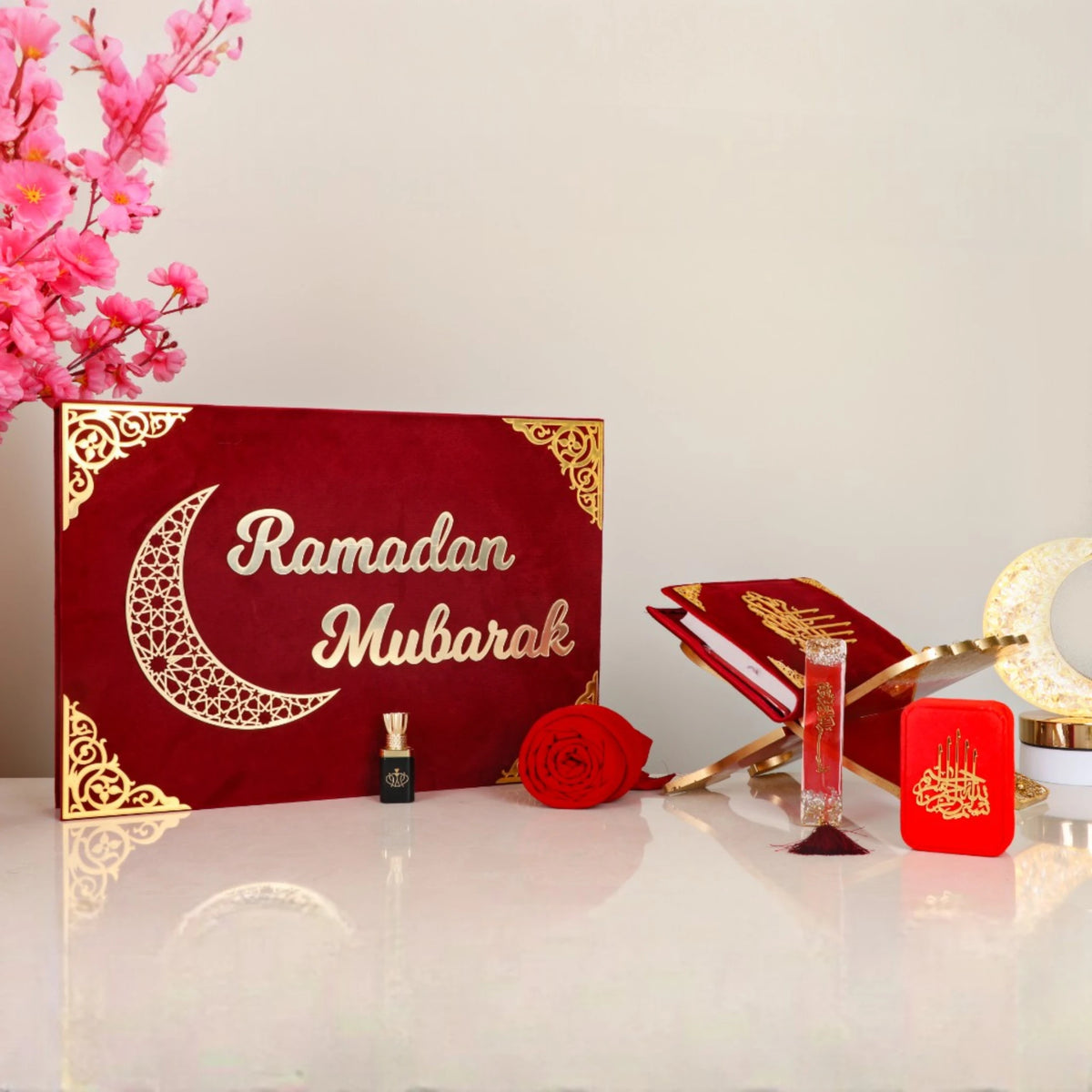 Elegant Jannah Treasures Ramadan Hamper in red with 'Ramadan Mubarak' design, includes Quran, miswak, tasbeeh, and rose decor for festive gifting.